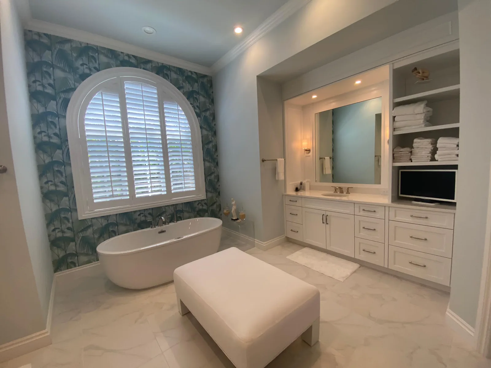 Bath with a freestanding tub beneath an arched window — Loxahatchee Club, Jupiter, FL