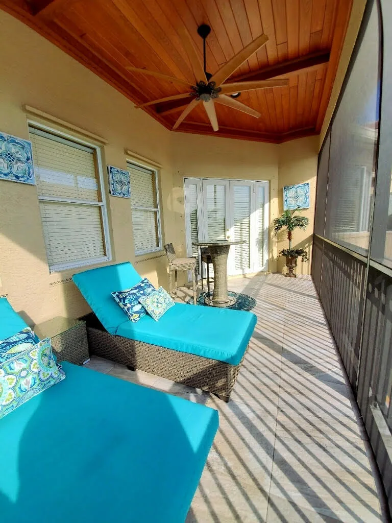 Covered lanai with a wood ceiling and lounge seating — Olympia, Wellington, FL