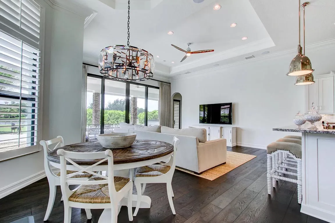Dining area with a chandelier and lake view — Frenchman's Harbour, North Palm Beach, FL