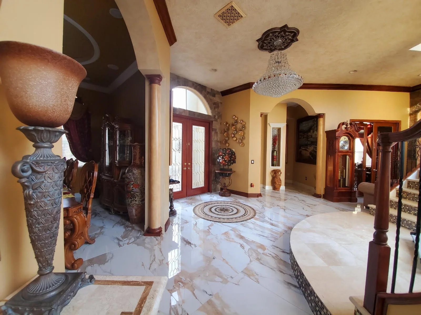 Foyer with marble floor, chandelier and curved staircase — Olympia, Wellington, FL