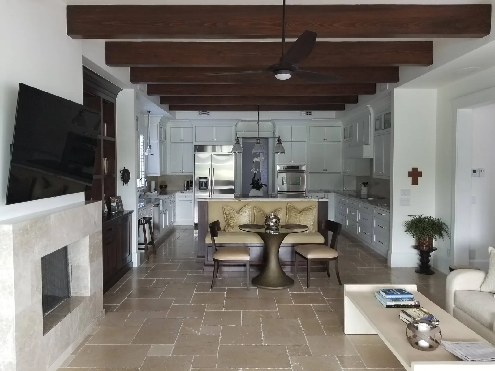 Great room with stone fireplace, beamed ceiling and open kitchen — Loxahatchee Club, Jupiter, FL