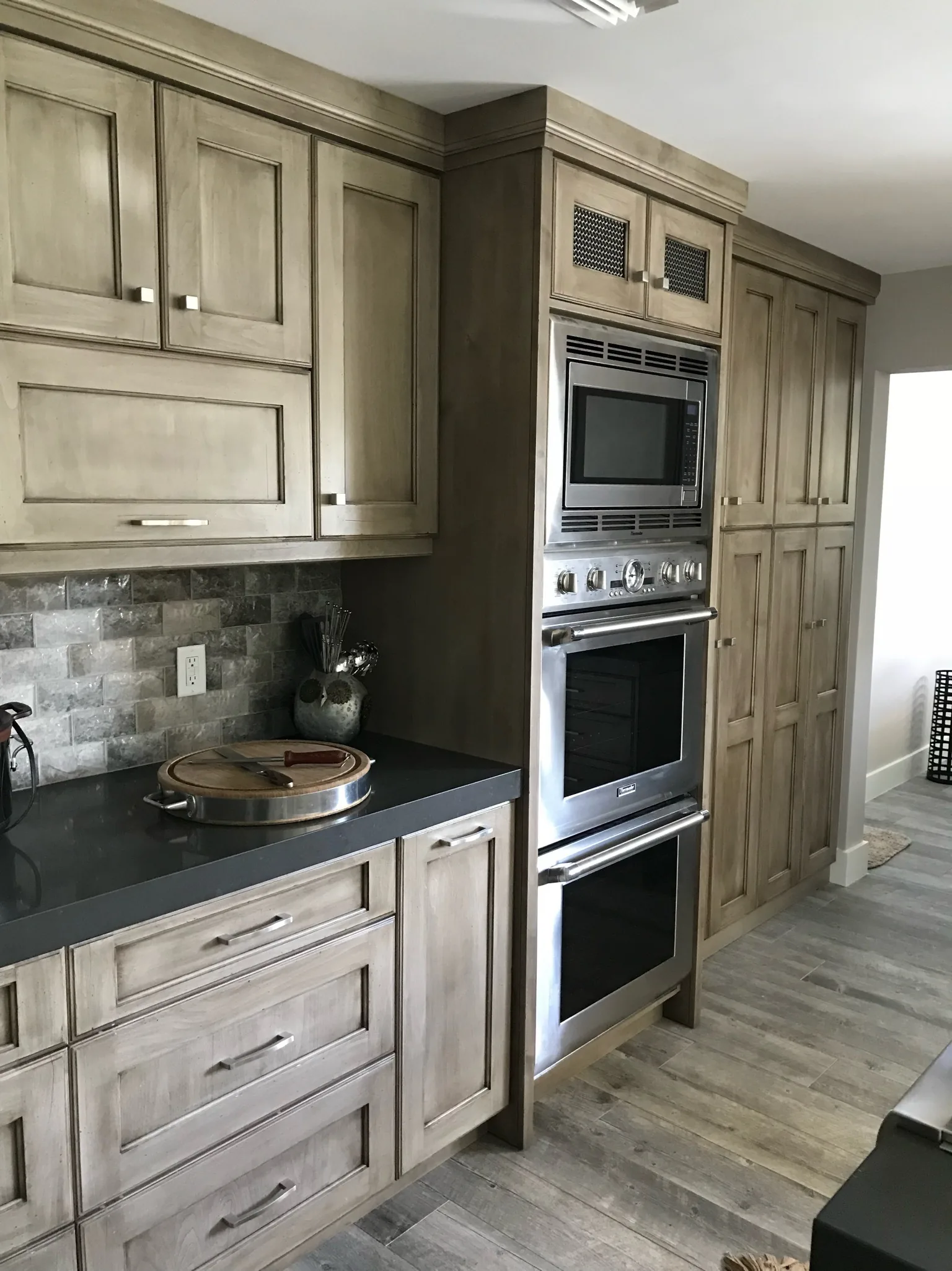Kitchen with gray-stained cabinets and a double wall oven — Caloosa, Palm Beach Gardens, FL