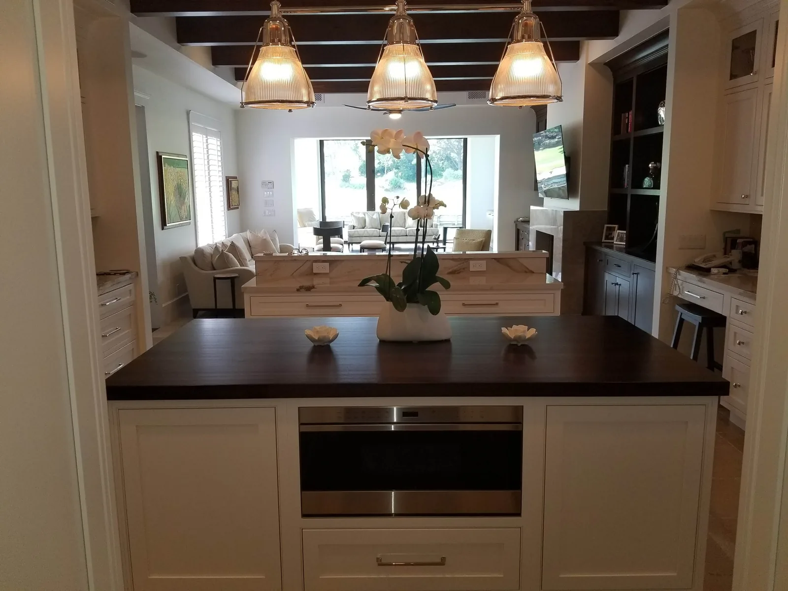 Kitchen island with a dark wood top and glass pendant lights — Loxahatchee Club, Jupiter, FL