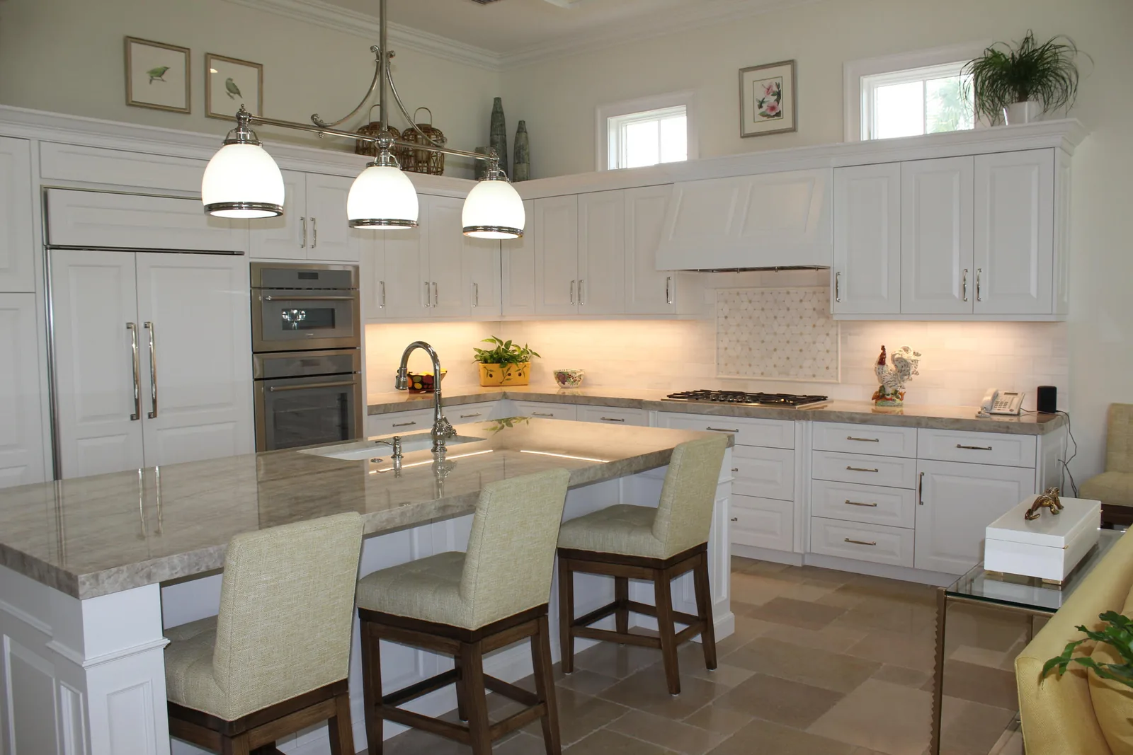 White kitchen with island seating and pendant lights — Loxahatchee Club, Jupiter, FL