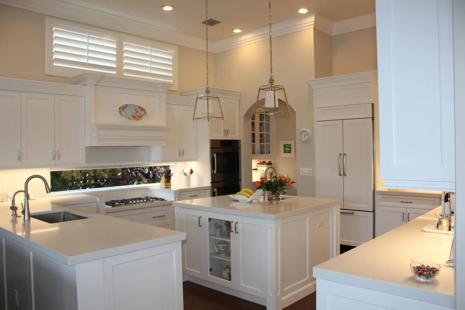 White kitchen with a large island and plantation shutters — Loxahatchee Club, Jupiter, FL