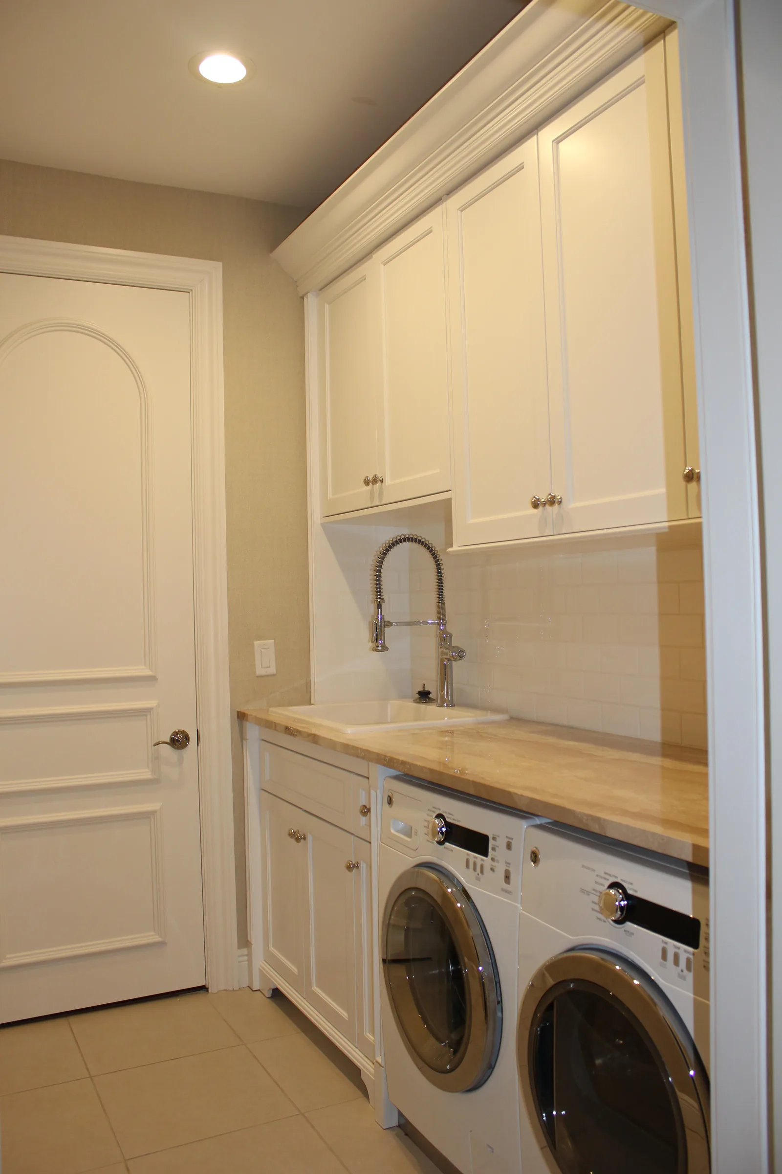 Laundry room with custom white cabinetry — Loxahatchee Club, Jupiter, FL