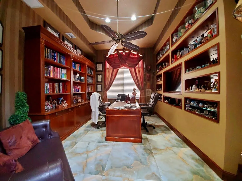 Library with floor-to-ceiling cherry built-ins and marble floor — Olympia, Wellington, FL