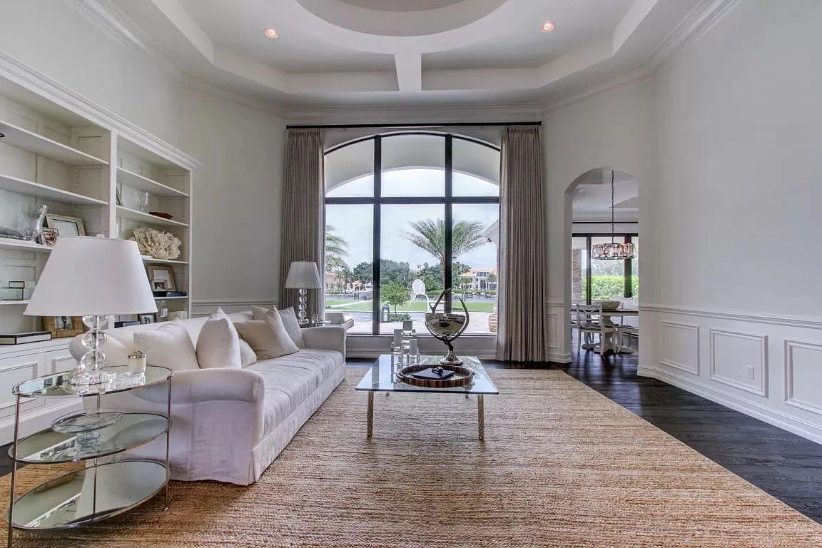 Living room with an arched window and built-in shelving — Frenchman's Harbour, North Palm Beach, FL