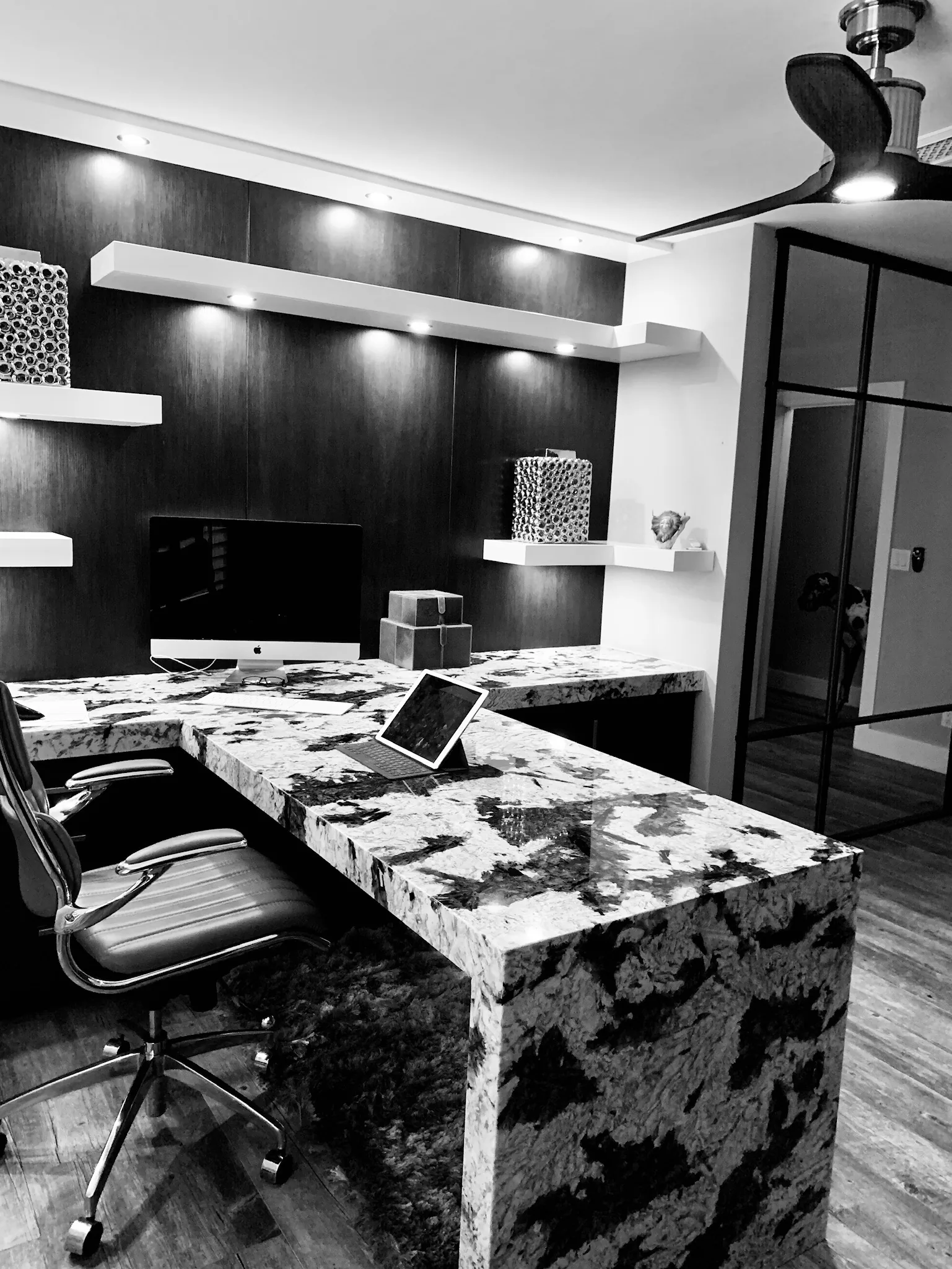Office with a granite waterfall desk and floating shelves — Caloosa, Palm Beach Gardens, FL