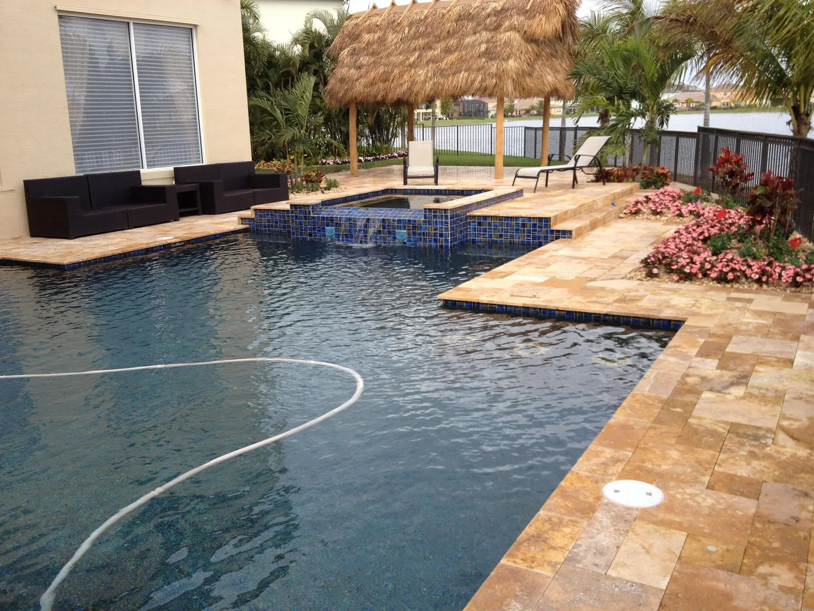 Pool and spa with travertine deck and a tiki hut — Olympia, Wellington, FL