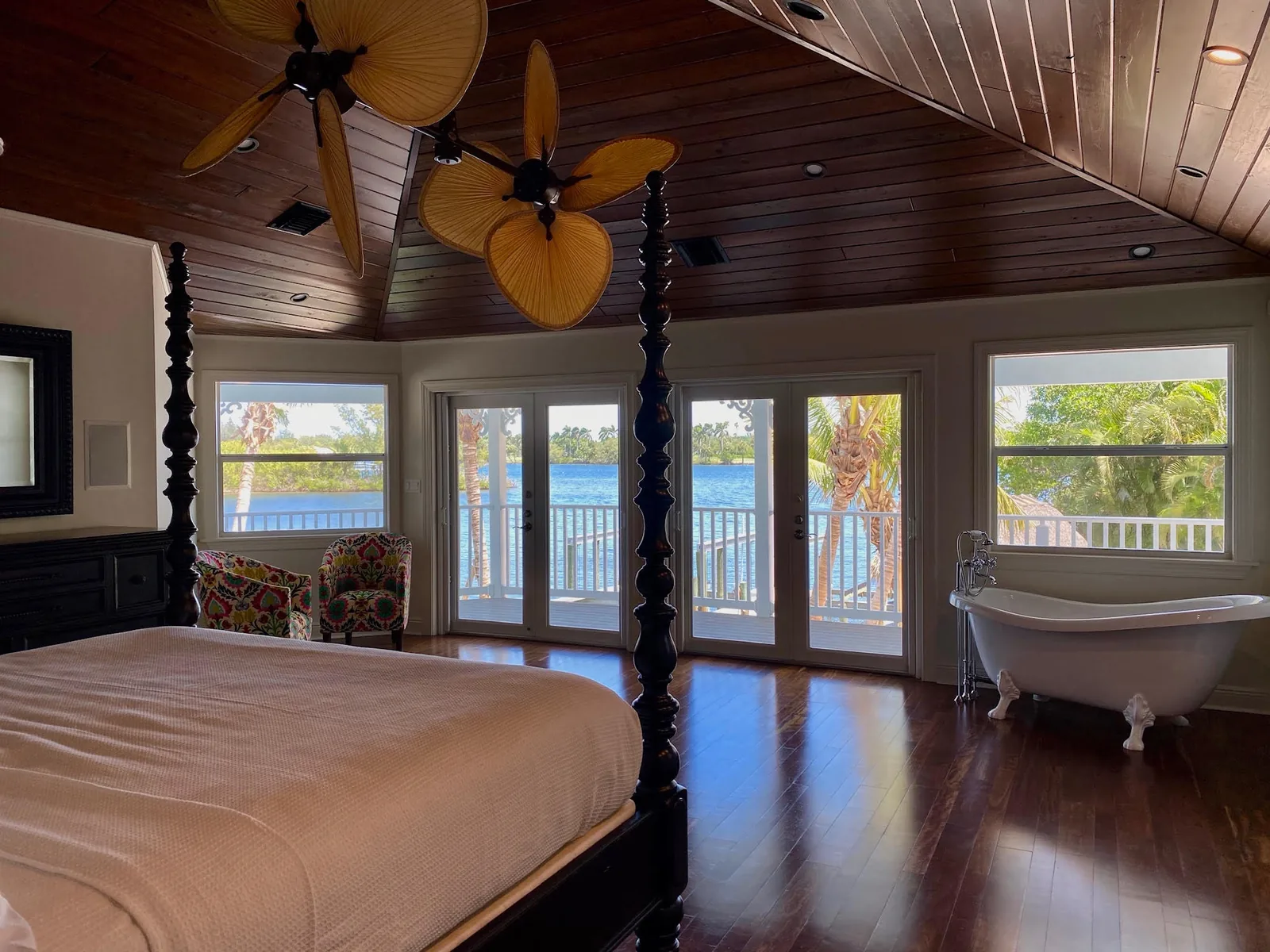 Bedroom with wood ceiling, four-poster bed and water view — Indian River, Hobe Sound, FL