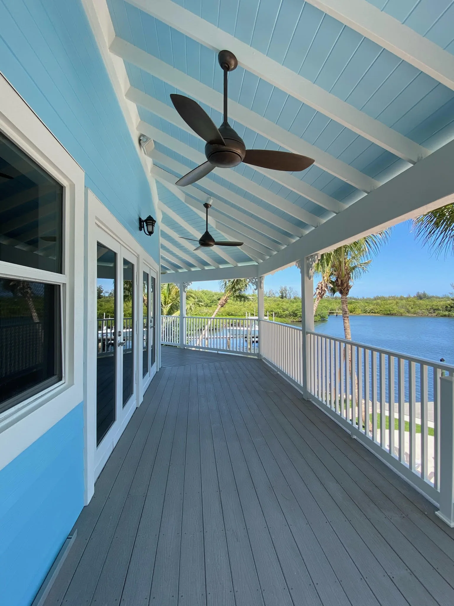 Covered porch with ceiling fans overlooking the water — Indian River, Hobe Sound, FL