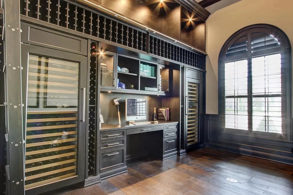 Bar with dark cabinetry and wine storage — Frenchman's Harbour, North Palm Beach, FL