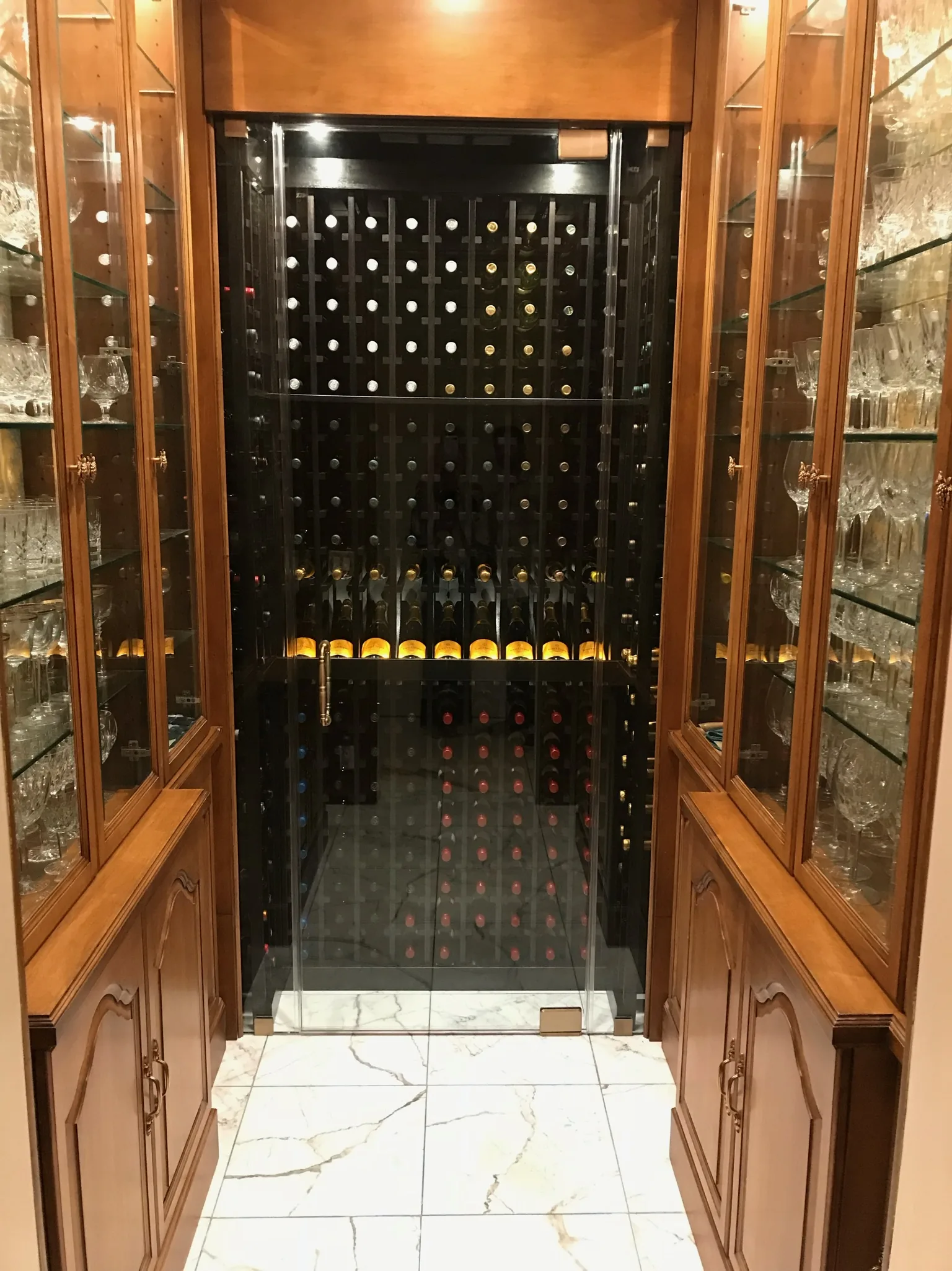 Wine room with wood racks and a glass door — Casa de Marbella, Palm Beach Gardens, FL